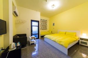 a bedroom with a yellow bed and a couch at Nice Guanxi in Guanxi +7 photos