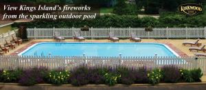 a swimming pool in a yard with chairs and purple flowers at Kirkwood Inn in Mason