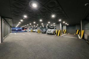 a large parking garage with cars parked in it at Bcent hotel in Busan