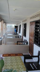 a room with wine racks and a woman in the background at Beach Guest House in Maninjau