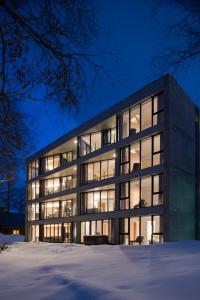 an office building with illuminated windows at night at Kozue in Niseko