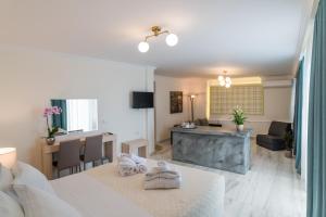 a hotel room with a bed and a living room at Castello Boutique Rooms in Kavála