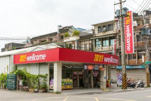 a building with a red sign on a street at Nice Guanxi in Guanxi