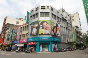 a building with advertisements on it on a city street at Nice Guanxi in Guanxi