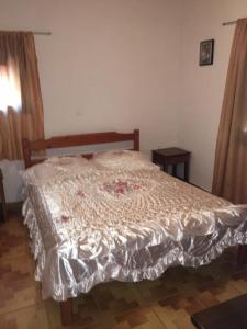 a bedroom with a bed with a comforter on it at Princess Studios in Afiartis +12 photos
