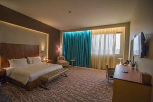 Postel nebo postele na pokoji v ubytování Millennium Hail Hotel