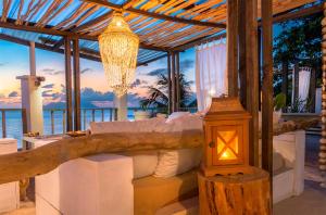 a hotel room with a balcony overlooking the ocean at Bliss Boutique Hotel Seychelles in Glacis