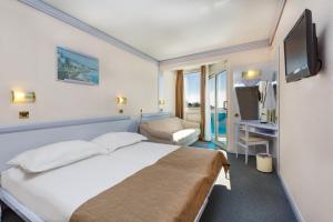 Ein Bett oder Betten in einem Zimmer der Unterkunft Hotel Plavi Plava Laguna