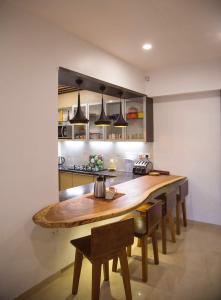 a kitchen with a large wooden table and chairs at Lavasa Luxury Deck Apartment in Lavasa