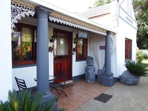 a house with a statue on a patio at Villa Luca Guesthouse & Chalets in Swartruggens