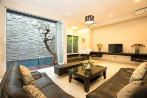 a living room with a couch and a table at InKuta Residence and Villa in Seminyak