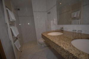 
a bathroom with a sink, toilet and bathtub at Hotel Auf dem Kamp in Hagen
