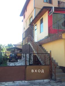 a building with a staircase next to a parking lot at Guest House PIP in Velingrad
