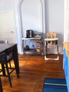 a kitchen with a table and a chair and a table at Le Nid De La Chouette in Dijon +13 photos