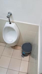 a bathroom with a toilet and a bidet at Crossroads Hostel Manila in Manila