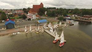 a group of sailboats in the water near a dock at Dom Żeglarza in Puck +23 photos