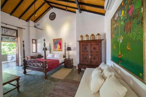 ein Schlafzimmer mit einem Bett und einem Wandgemälde in der Unterkunft Nyne Hotels - The Muse, Bentota in Bentota