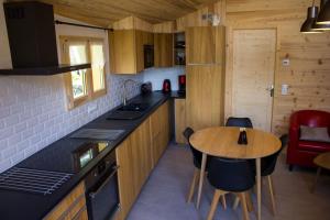 a kitchen with a table and a counter top at Le petit Saint Bernard in Sainte-Foy-Tarentaise