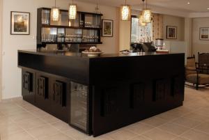 a bar with a black counter in a room at Fürjes Villa Panzió in Balatonfüred