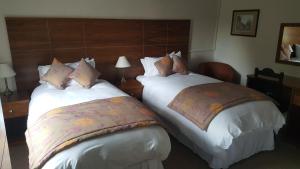 A bed or beds in a room at The Greyhound Hotel Cromford