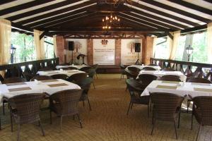 a dining room with white tables and chairs at Park-Hotel Golosievo in Kyiv