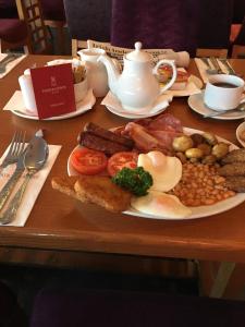 a table with a plate of breakfast food on it at Station House Hotel Letterkenny in Letterkenny