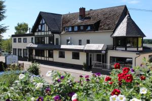 a large white building with a black roof at Landhotel Fernblick in Hümmerich