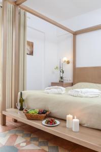 a bedroom with a bed and a table with a plate of food at Astir Of Naxos in Naxos Chora