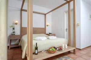a bedroom with a bed with a large mirror at Astir Of Naxos in Naxos Chora