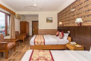 Uma cama ou camas num quarto em Hotel Tulsi