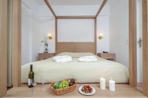 a bedroom with a bed with a basket of fruit on a table at Astir Of Naxos in Naxos Chora