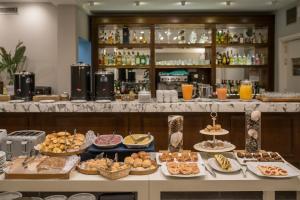 a buffet with many different types of food on a table at Playas Art Hotel in Pinamar