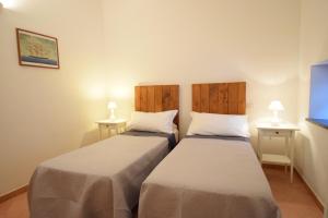 A bed or beds in a room at Casa della Marina - beach, seaview, wifi