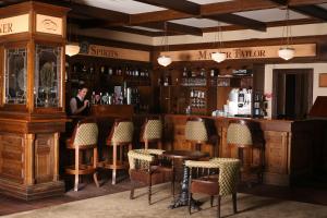 a man standing at a bar in a pub at Auburn Lodge Hotel & Leisure Centre in Ennis