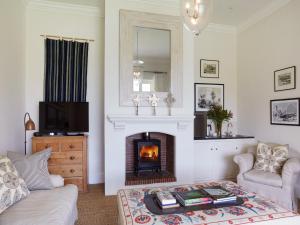 a living room with a couch and a fireplace at La Cotte House in Franschhoek