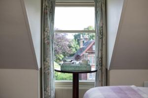 a room with a window with a table in front of it at Nether Abbey Hotel in North Berwick
