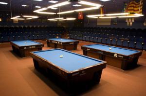 a row of pool tables in a room with chairs at Hotel Caseta Nova in Castalla