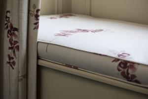 a close up of a bed with flowers on it at Nether Abbey Hotel in North Berwick