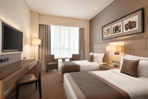 Postel nebo postele na pokoji v ubytování TRYP by Wyndham Abu Dhabi City Center