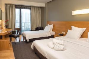 Ein Bett oder Betten in einem Zimmer der Unterkunft Esperos Palace Luxury & Spa Hotel