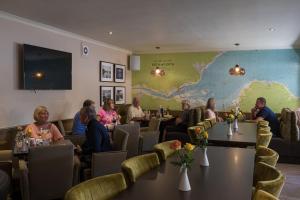 a group of people sitting at tables in a restaurant at Nether Abbey Hotel in North Berwick