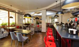 a restaurant with tables and chairs and a bar at Wellotel Yuzhne in Yuzhne