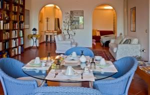 a living room with a table with blue chairs at Il Giardino di Matilde in Perugia