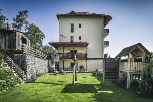 a house with a yard in front of a building at Villa Krejza in Vysoke Tatry - Horny Smokovec