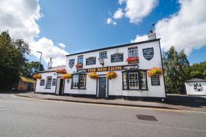 a white building on the corner of a street at The Red Lion in Cambridge