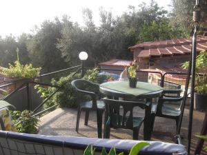 a patio with a table and chairs on a balcony at B&B L'Arcobaleno in Sorrento