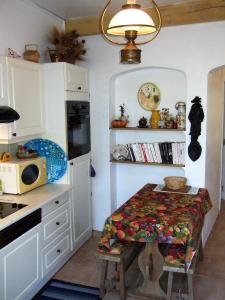 uma cozinha com uma mesa no canto de um quarto em AU VALLON ROUGE (Studio) em Saint-Paul-de-Vence