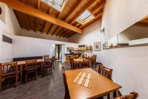 a dining room with wooden tables and chairs at The Paddock B&B in Müllenbach