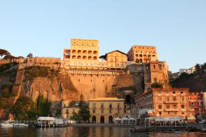 a group of buildings on the side of a mountain at Surriento Suites in Sorrento