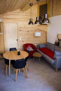 a living room with a couch and a table at Le petit Saint Bernard in Sainte-Foy-Tarentaise